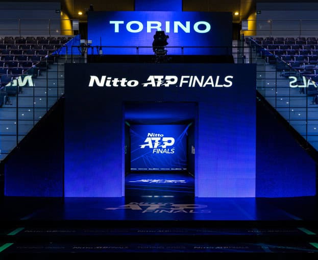 ATP Finals Turin stage with blue lighting and branding.