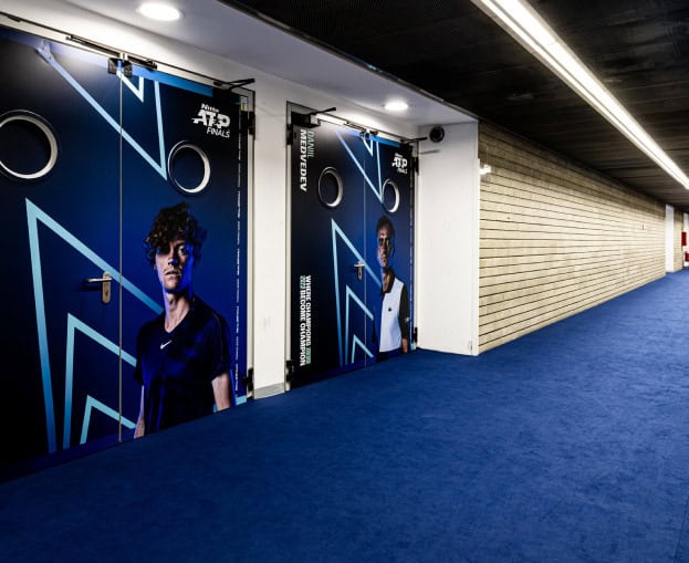 ATF Finals Turin entrance with promotional posters of tennis players.