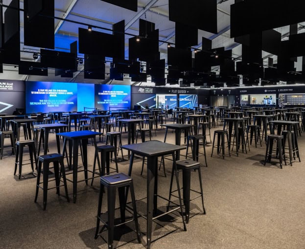 Empty event space with tables and stools at ATP Finals Turin.