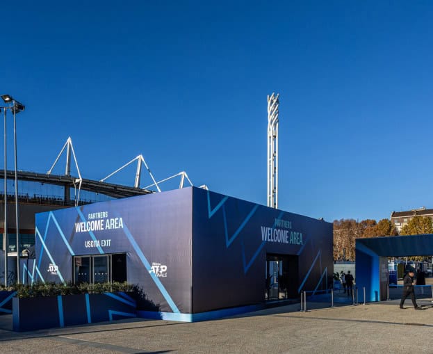 ATP Finals Turin entrance with modern blue structures and clear sky.