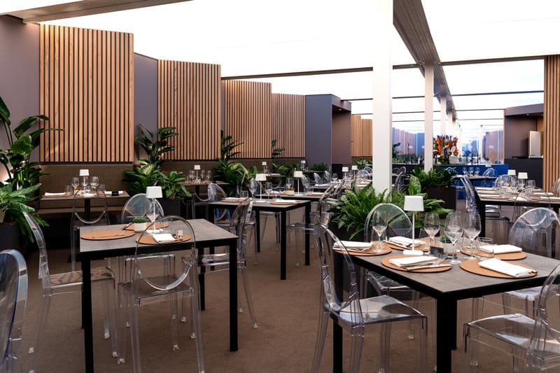Elegant modern restaurant interior with stylish decor and city view.